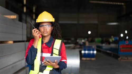Industrial Engineers or Foreman inspecting and check up machine at factory machines.Technician working in metal sheet at industry.