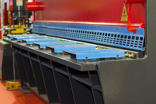 close up large metal sheet cutting machine for industrial in manufacturing process at factory