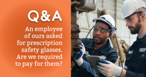 two men with safety glasses on in manufacturing setting looking at machinery