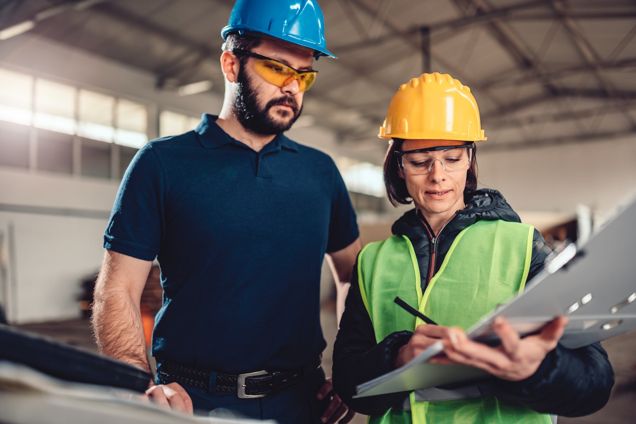 Employee in charge of safety in facility with a safety inspector