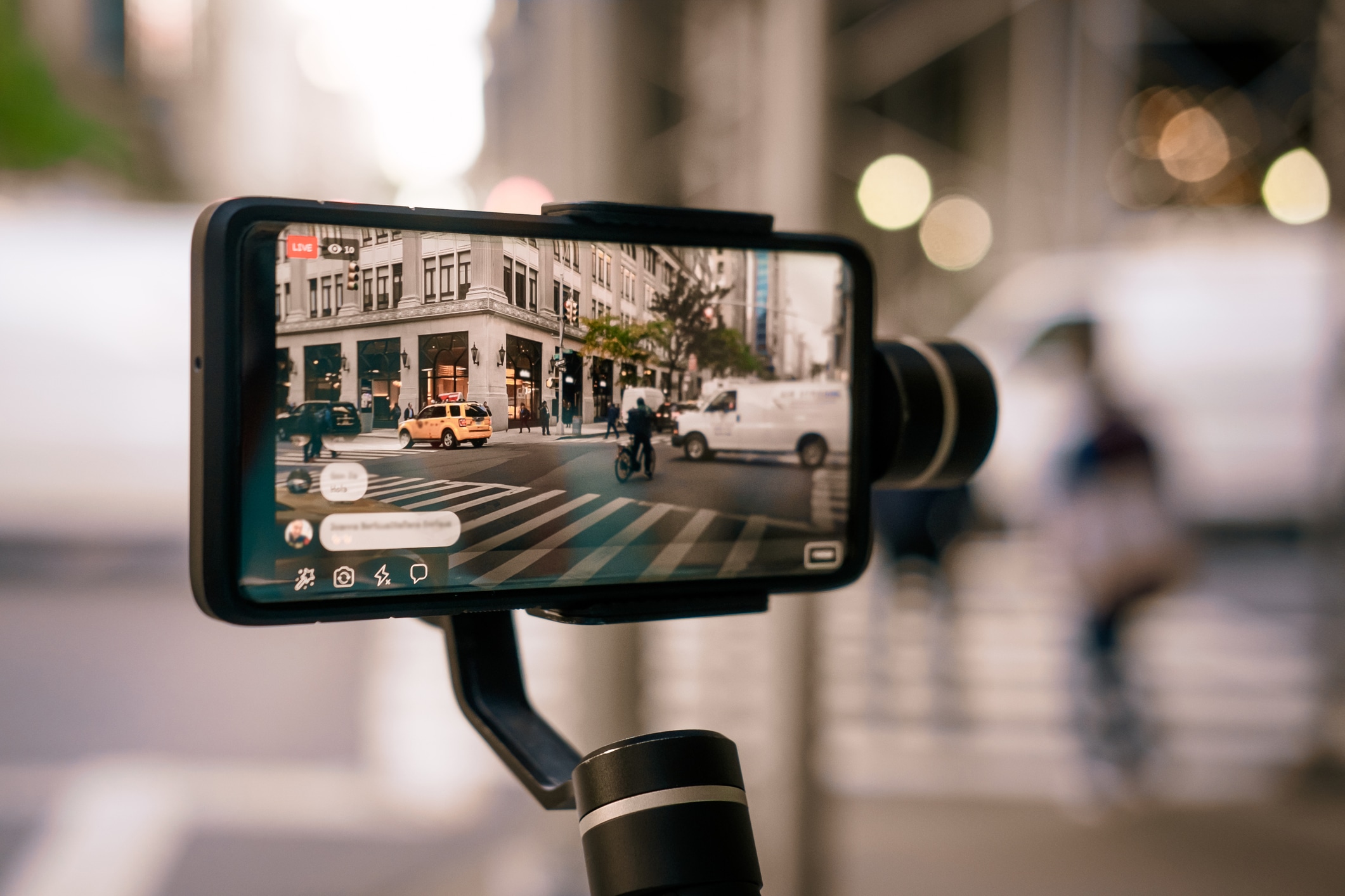 Man using phone with stabilizer and taking pictures and live video