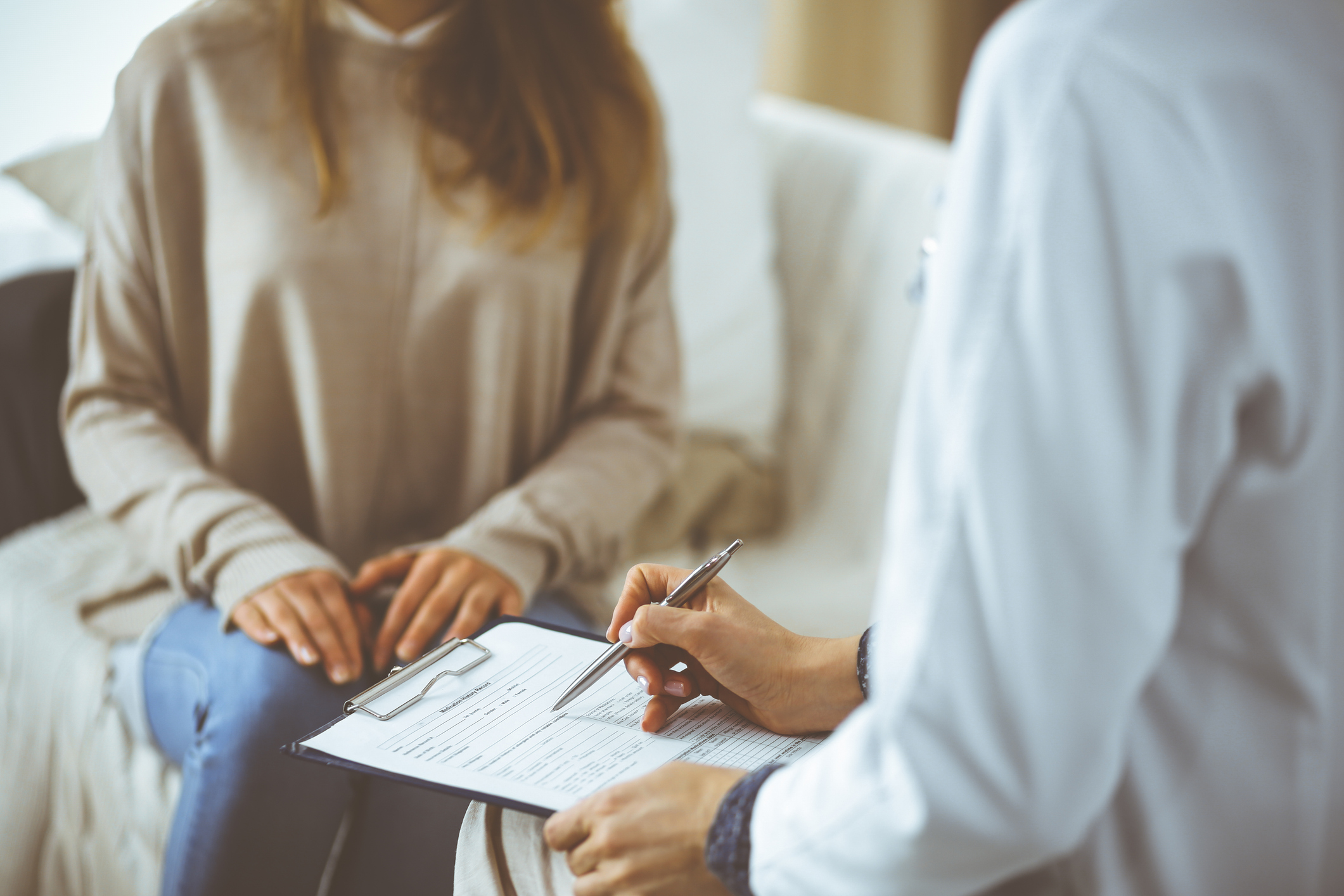 woman-doctor and patient discussing current health issues