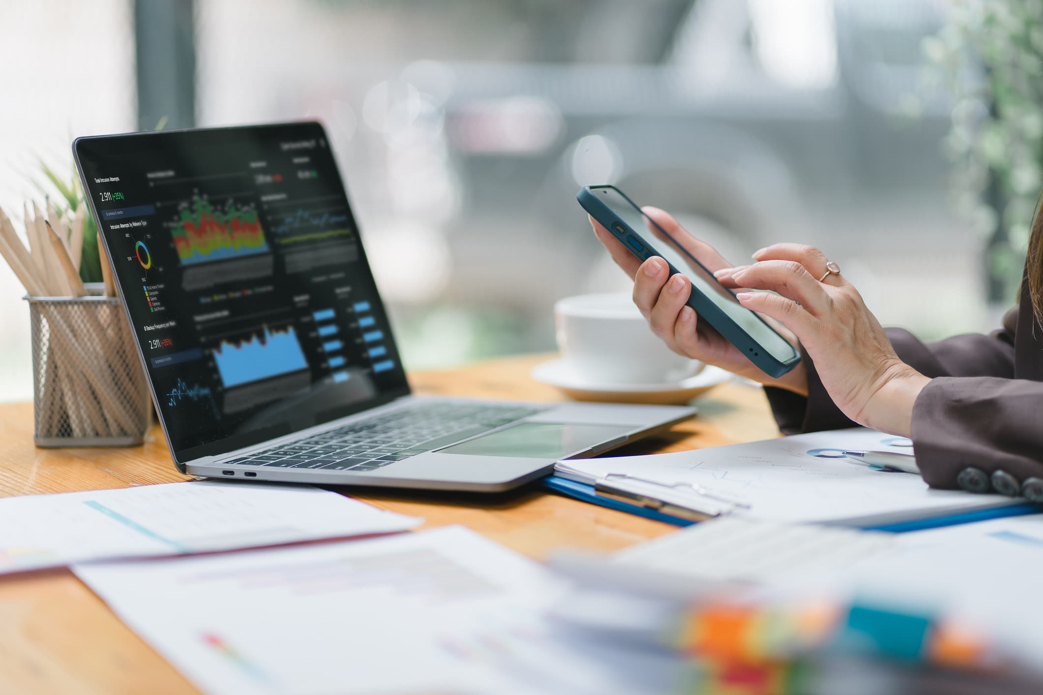 A businesswoman or accountant using laptop to analyze financial investments and business and marketing growth on a data graph. The concepts of accounting, economics, and commercial analysis