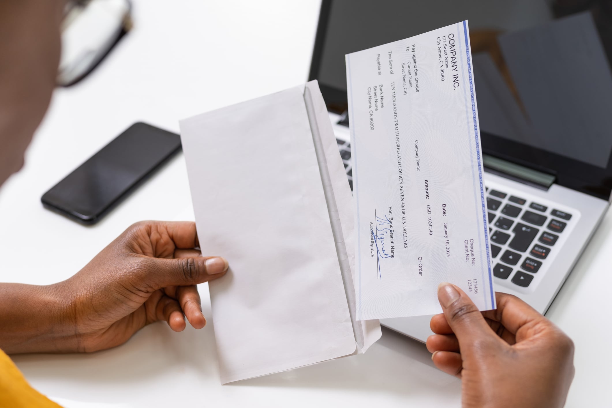 American African Holding Paycheck Or Payroll Check