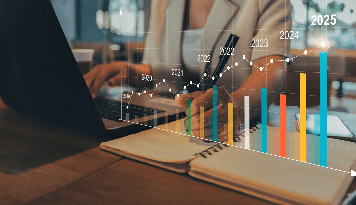 woman on computer with graph showing costs higher in 2025