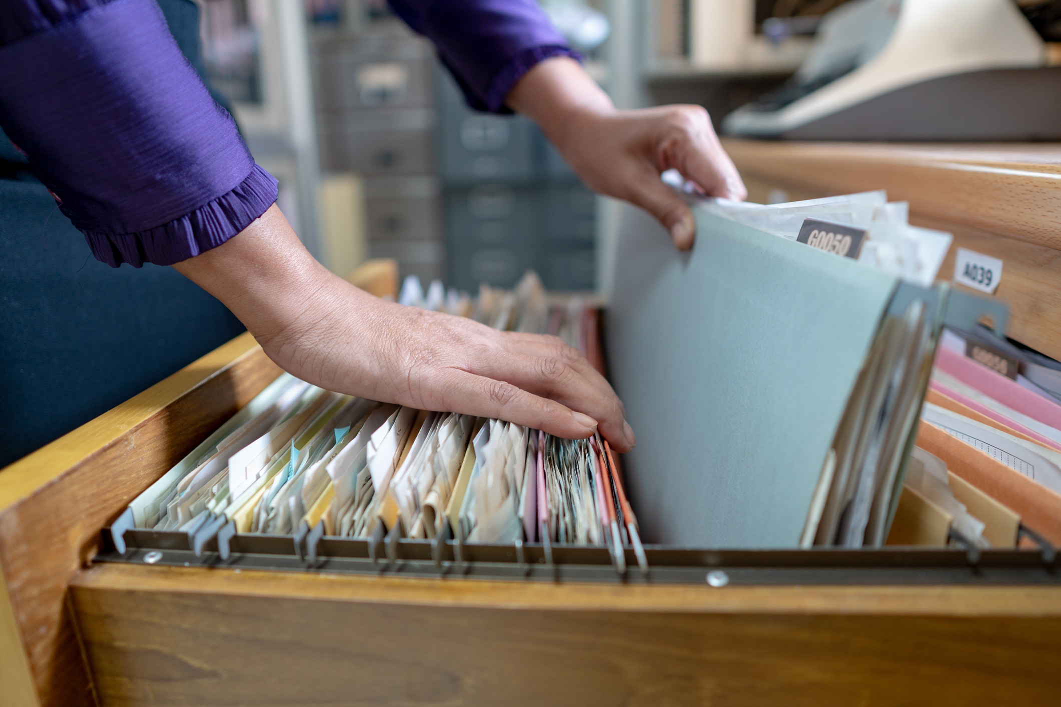 Woman Removing File At Office