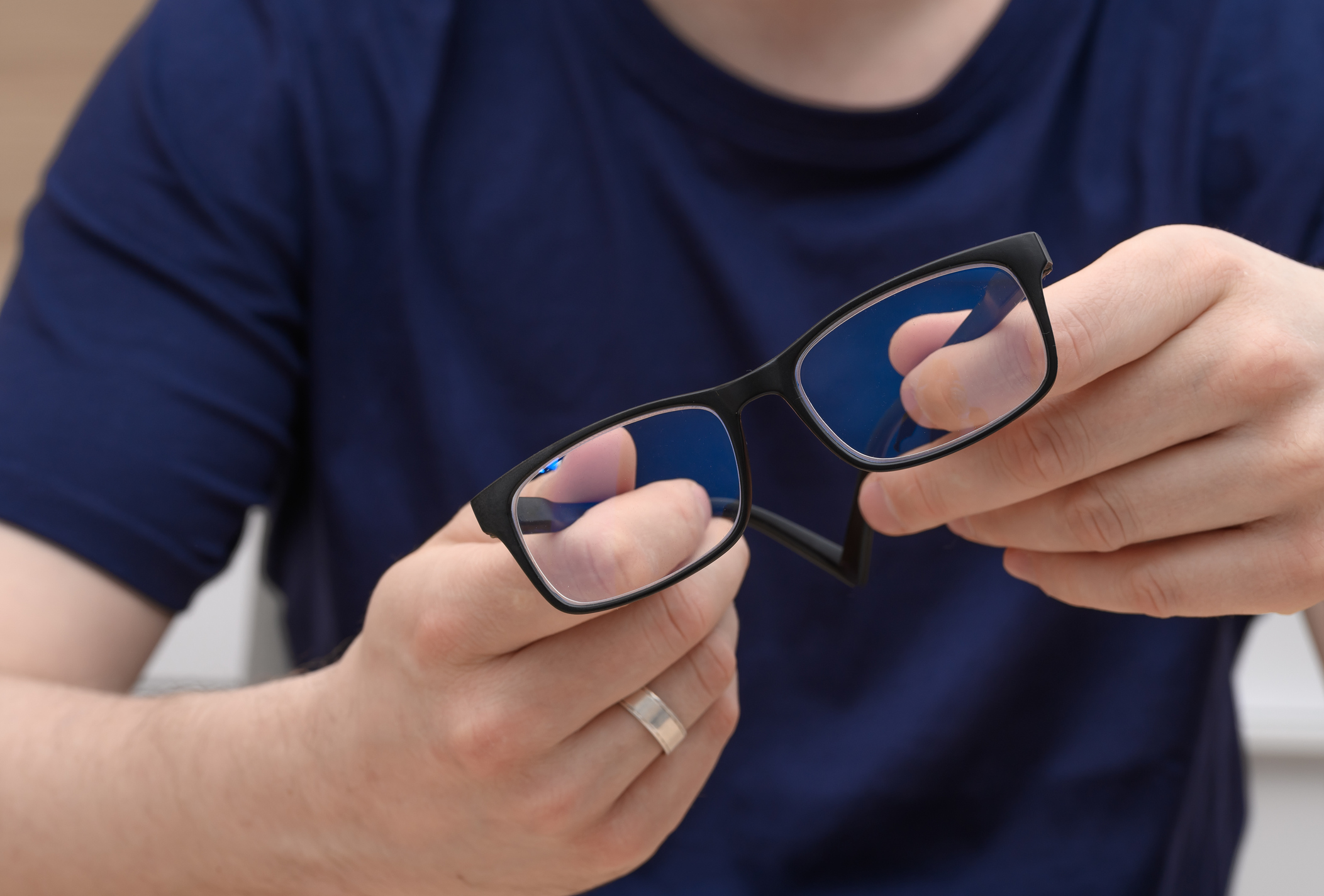 A man checks his AI-equipped smart glasses,