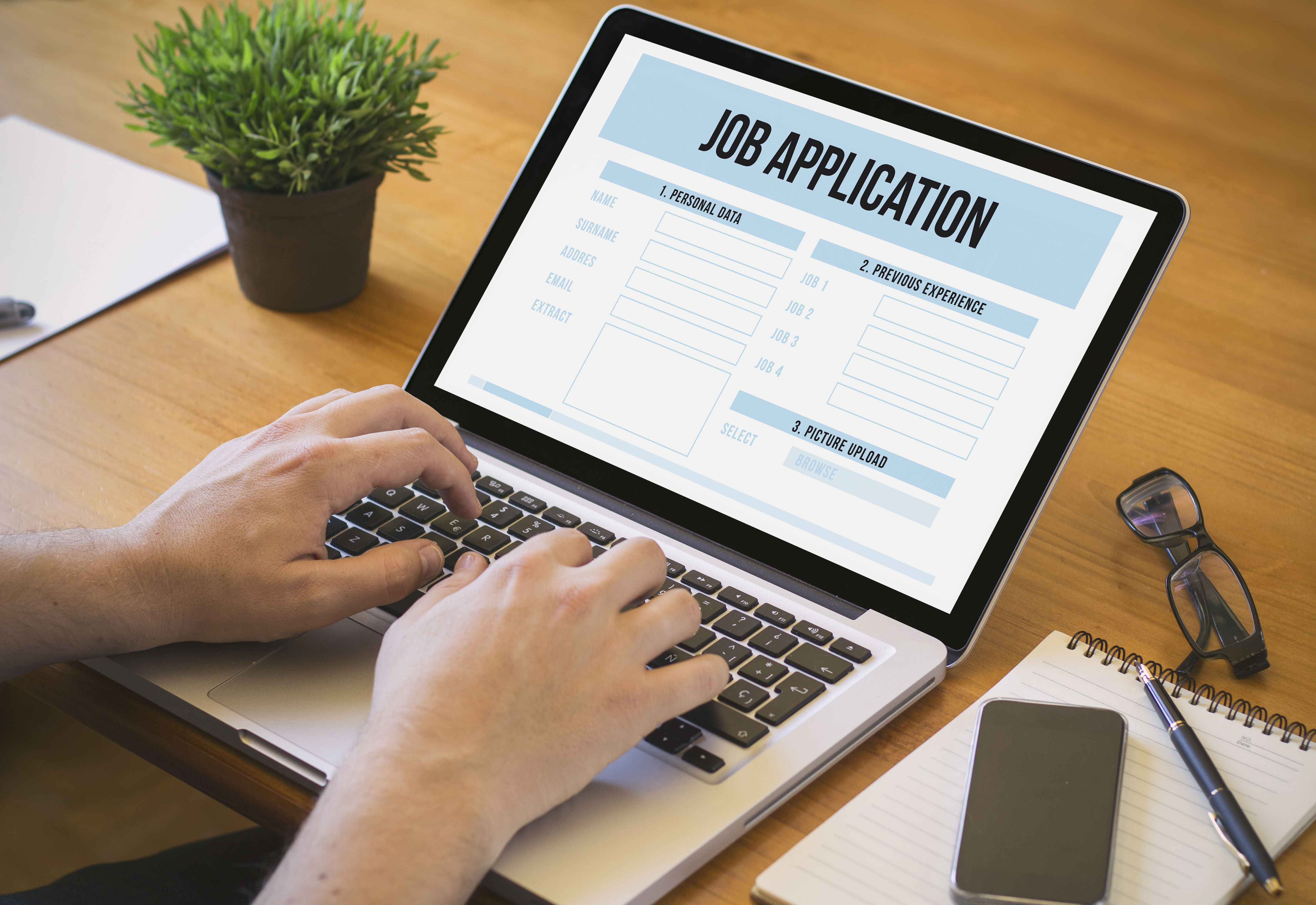 person applying for a job on a laptop