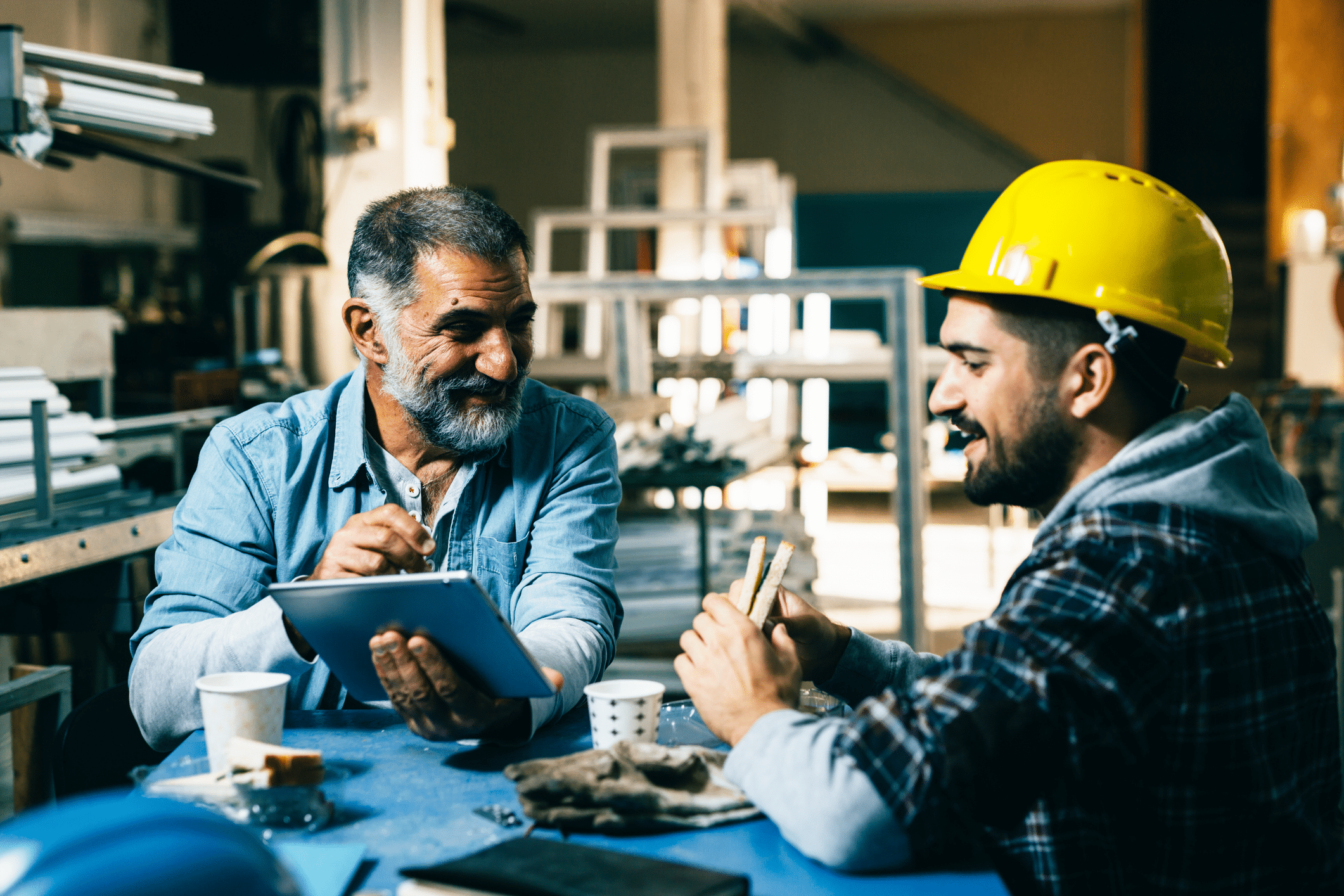 two men having meal period at industrial job