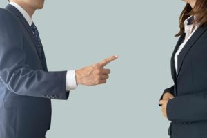 A male boss and a female subordinate giving warnings and power harassment