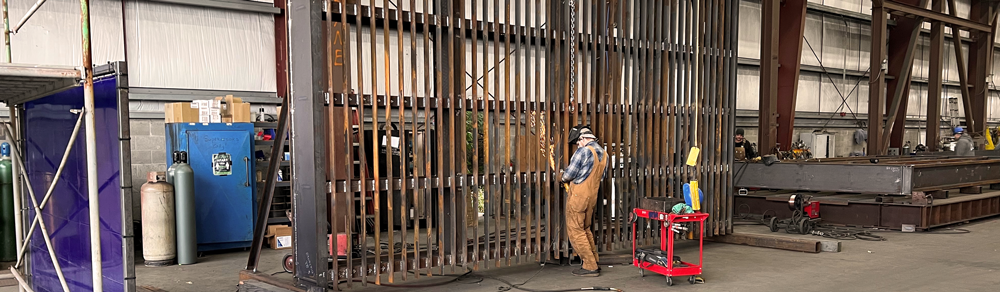 worker welding a rack; steel fabrication