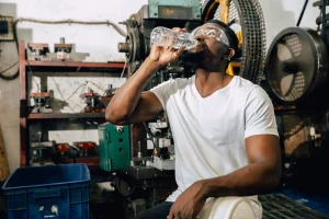 Man sitting down drinking water